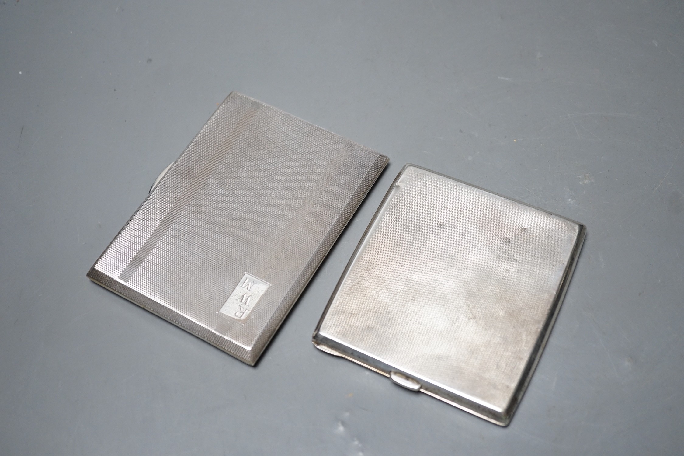Two engine turned silver cigarette cases, largest 11.2cm